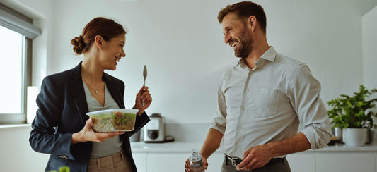 Two colleagues preparing a high-fibre lunch together in a bright office kitchen