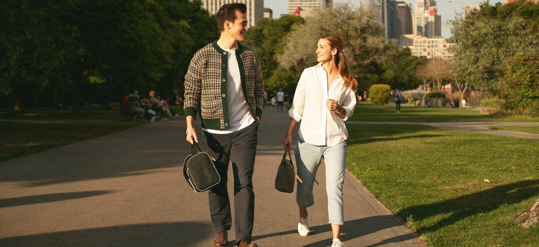 Two young adults enjoying a relaxed walk in a sunny urban park