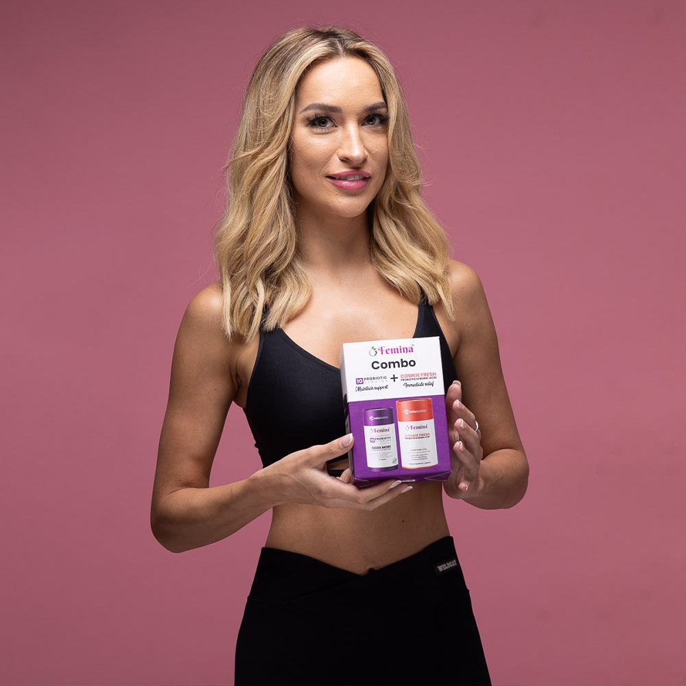 Woman holding Femina COMBO Care probiotics supplement packaging for feminine wellness on pink background