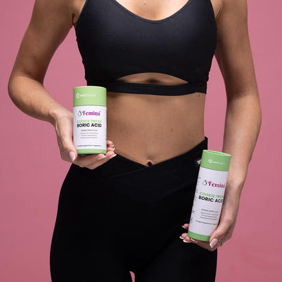 Woman holding Femina Cookie Fresh Boric Acid suppositories for intimate health balance and relief