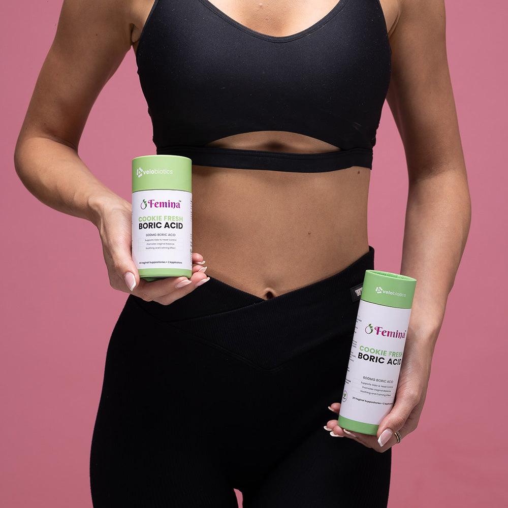 Woman holding Femina Cookie Fresh Boric Acid suppositories for intimate health balance and relief