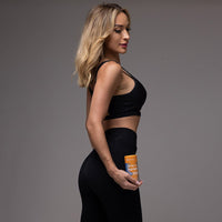 fit woman holding GutSlim Probiotics fat burner supplement bottle promoting gut health and weight loss