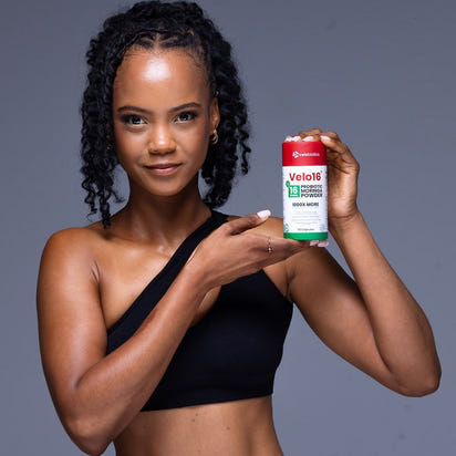 Woman holding Velo16 Probiotics Moringa supplement container for gut health and vitality